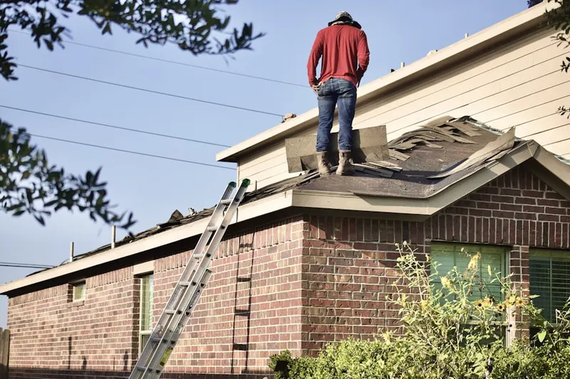 Professional roofer working on a residential roof in Wooldlawn Heights